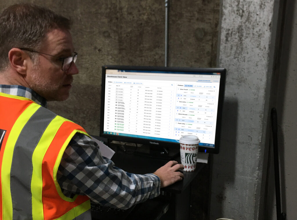 Warehouse Clerk Assigning Orders To Pickers On Desktop Web App